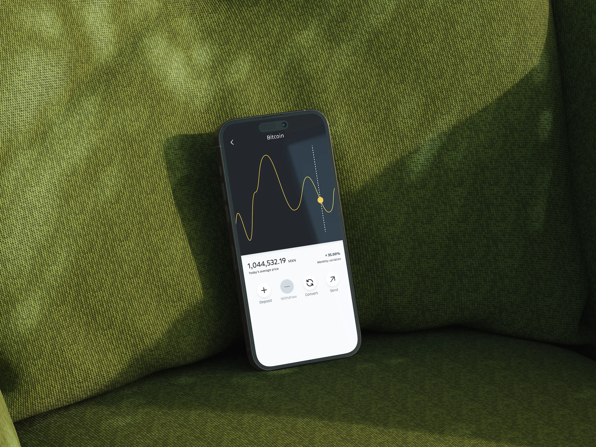Bitso bitcoin price chart on a phone resting on a green couch